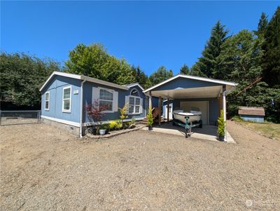 West side home with car port, detached garage & shop. | Image 2