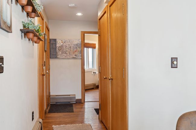 View from living area, looking at main door on left. There is an unloading area with bench to the right, and the bedroom is next to that. Bathroom is between the main entrance and the bedroom. | Image 10