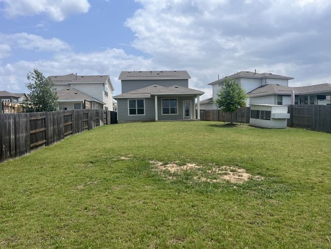 Back of property with a lawn and a fenced backyard | Image 7