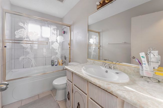 Bathroom with vanity, shower combination, and tile patterned flooring | Image 13