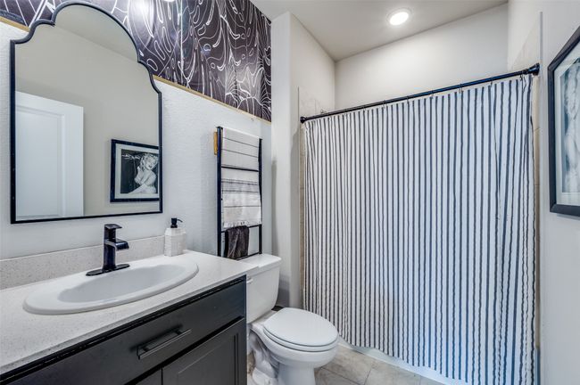 Bathroom featuring tile patterned floors, toilet, a shower with shower curtain, and vanity | Image 17