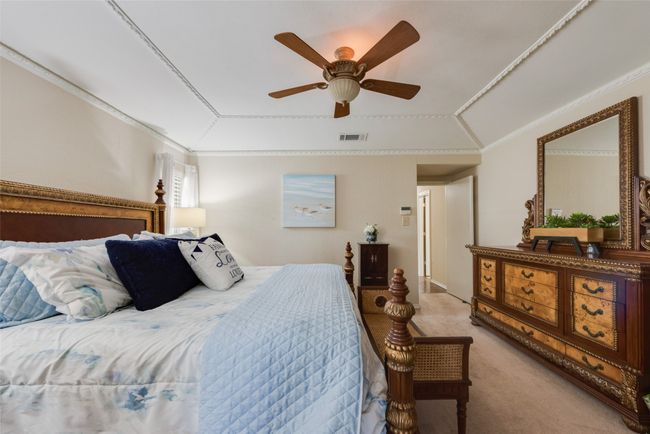 Carpeted bedroom featuring a ceiling fan and ornamental molding | Image 21