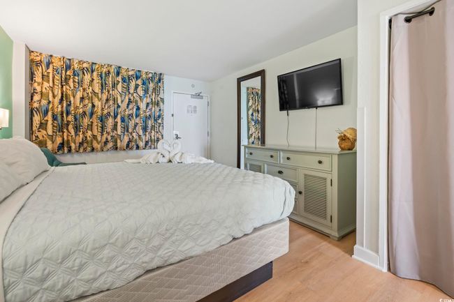 Bedroom with light wood-type flooring and baseboards | Image 5