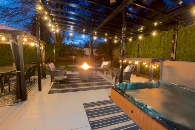 Patio at twilight featuring a gazebo, a covered hot tub, and a fire pit | Image 30