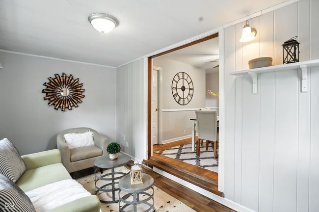 living area featuring wood finished floors, ceiling fan, and ornamental molding | Image 20