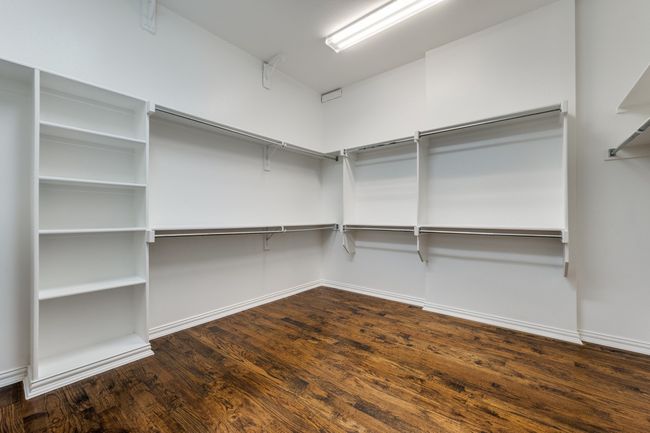Spacious closet with wood finished floors | Image 10