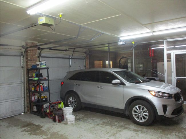 Garage with a garage door opener | Image 10