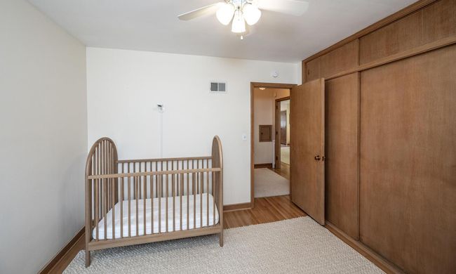 Second bedroom on the main floor includes a ceiling fan and ample closet space. | Image 16