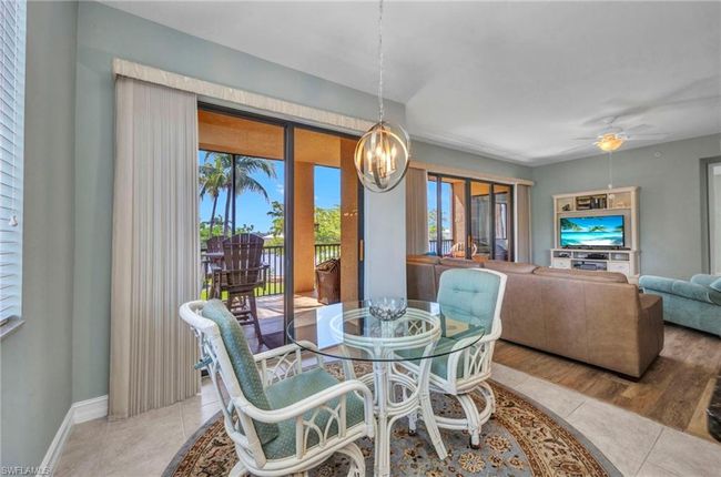 Dining space featuring a chandelier and ceiling fan | Image 12