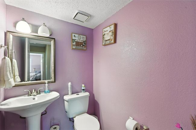 Half bath featuring toilet and a textured ceiling | Image 19