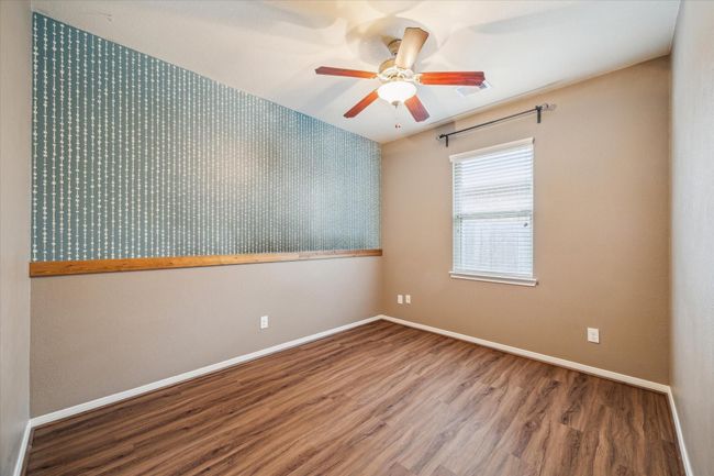 Secondary bedroom featuring elegant wall molding enhances the room's modern charm. | Image 29