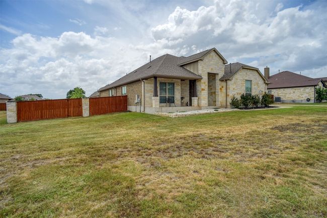 View of front of home with stone siding and a shingled roof | Image 33