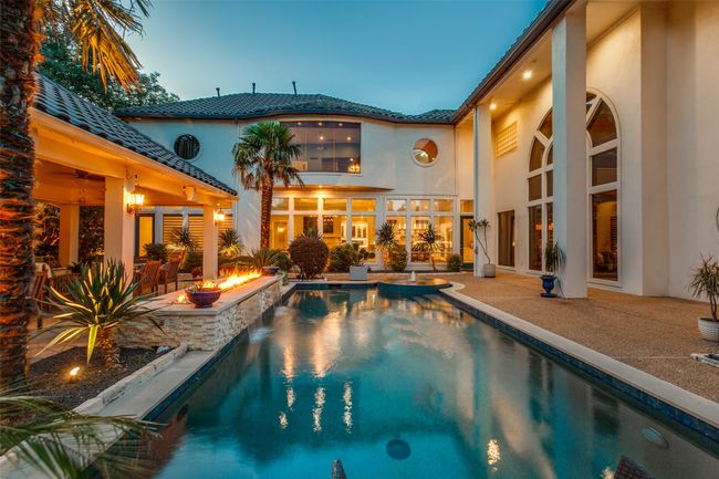 This is entertaining at your finest, with a silky pool & spa, recently resurfaced in high-end aggregate, the tranquil sound of waterfalls flowing to the pool below the firepit, plenty of poolside decking area for lounges and chairs and beautiful illumination. | Image 31