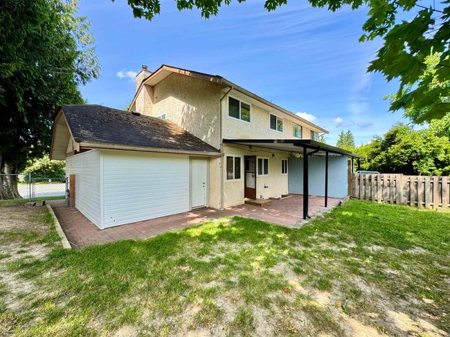 Back of house with a patio area, a chimney, and stucco siding | Image 23