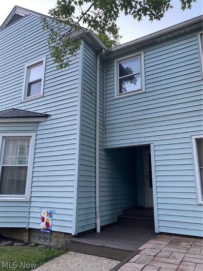 Side entrance to another foyer central to basement, kitchen, half bath, basement and family room | Image 2