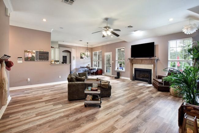 Living area with a fireplace, ceiling fan, crown molding, light wood-type flooring, and recessed lighting | Image 5