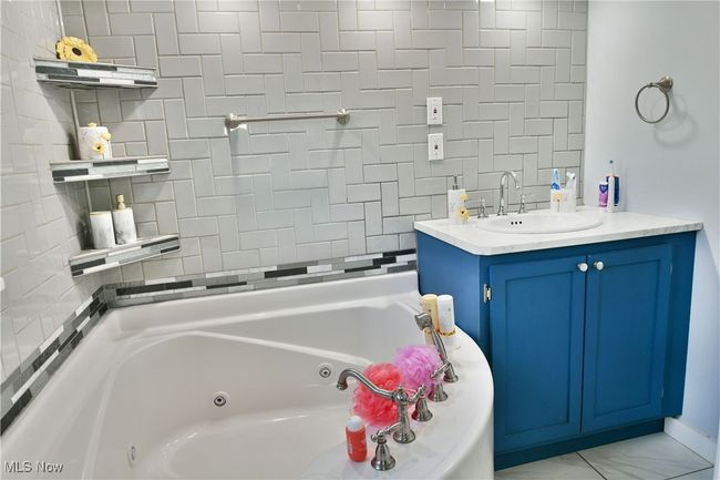 Bathroom with vanity and a jetted tub | Image 29