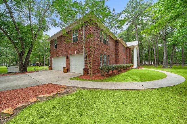 Welcome to 21992 Blazing Trail, New Caney, Texas, 77357, with a welcoming driveway and landscaped surroundings. | Image 46