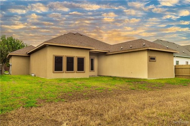 Back house at dusk featuring a yard | Image 17