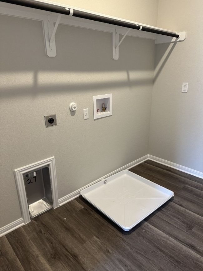 Laundry area featuring hookup for a gas dryer, electric dryer hookup, dark wood-style flooring, baseboards, and hookup for a washing machine | Image 13