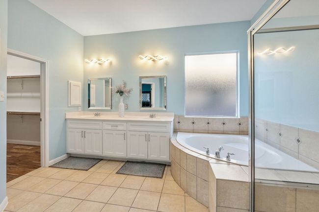 Large master bath includes double vanities, separate shown, garden tub and huge walkin closet. | Image 11