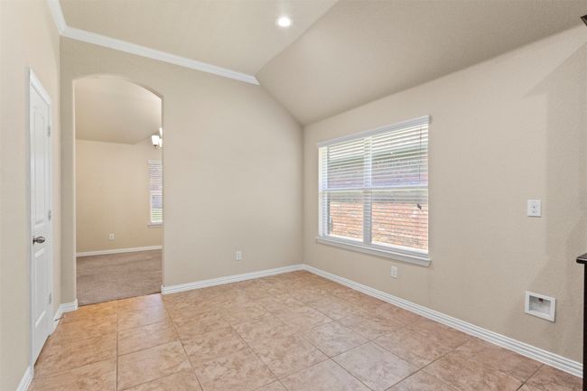 Spare room with arched walkways, crown molding, vaulted ceiling, and light tile patterned floors | Image 29