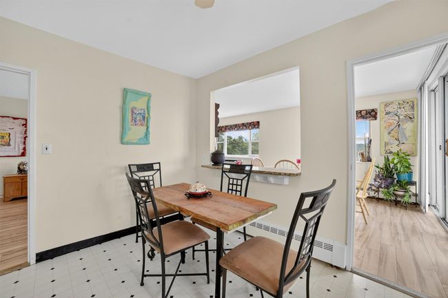 Dining area featuring a baseboard heating unit and baseboards | Image 19