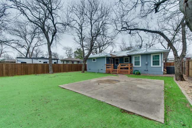 Back of house featuring a lawn, a fenced backyard, a deck, cooling unit, and a patio​​‌​​​​‌​​‌‌​‌‌​​​‌‌​​‌‌​‌​​​​​‌ area | Image 23