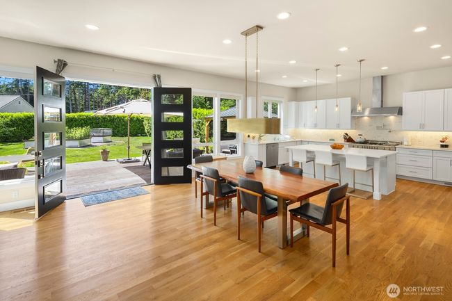 The great room flows seamlessly to the patio, making indoor/outdoor entertaining a breeze. | Image 7
