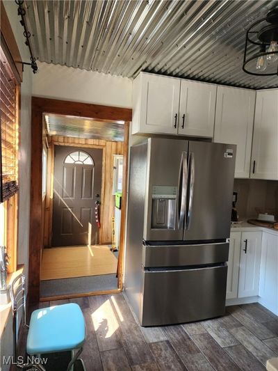 Kitchen with white cabinets and dark wood-type flooring | Image 2