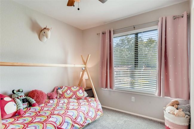 Bedroom with carpet floors, multiple windows, baseboards, and ceiling fan | Image 18