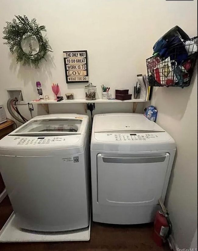 Clothes washing area featuring independent washer and dryer, laundry area, and dark wood finished floors | Image 11