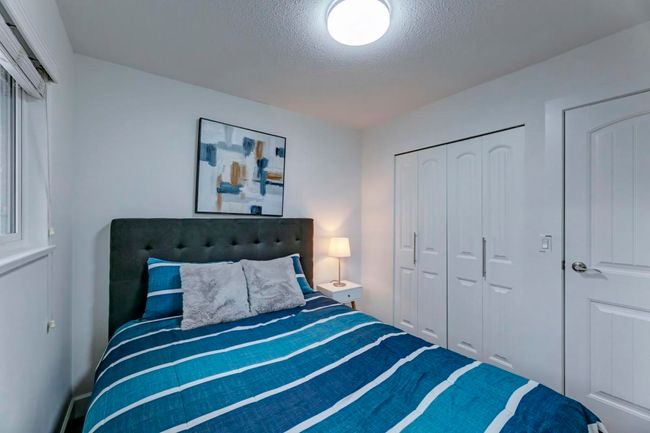 Bedroom with a closet and a textured ceiling | Image 24