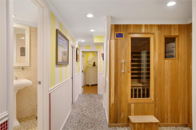 Hall featuring recessed lighting, a wainscoted wall, crown molding, and a sauna | Image 17