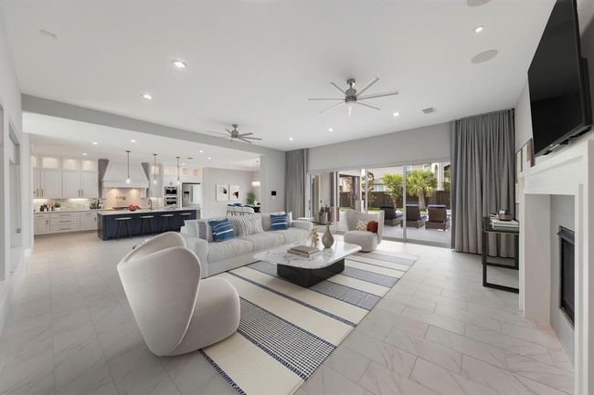 Designed for modern living and effortless entertaining, this expansive open-concept space connects a chef’s kitchen, stylish living area, and sun-soaked patio with fluid elegance and contemporary charm. *This photo has been virtually staged.* | Image 16