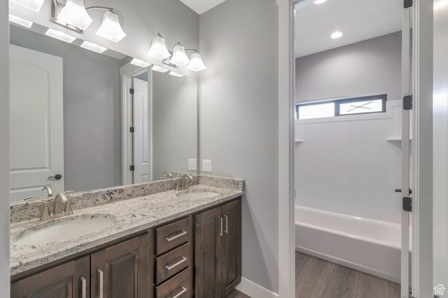 Full bath with double vanity and wood finished floors | Image 28