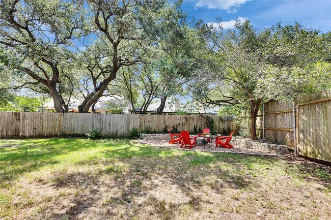 View of yard featuring an outdoor fire pit and a patio area | Image 35