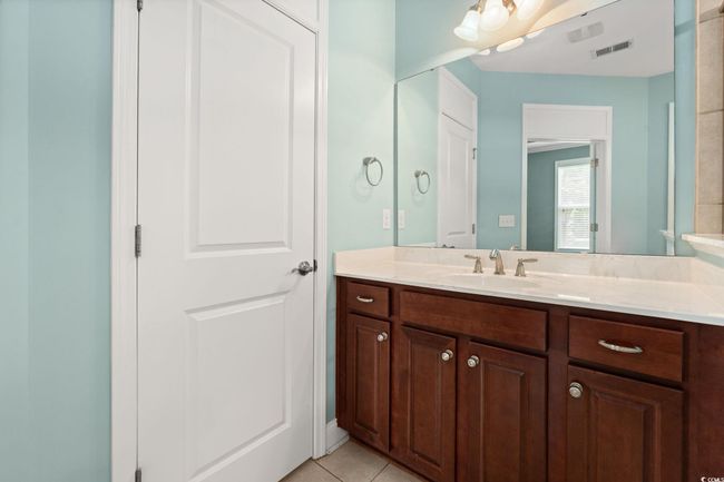 Bathroom with visible vents, tile patterned flooring, and vanity | Image 22