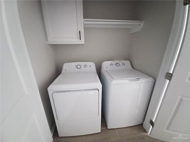 Laundry room featuring washer and dryer and cabinet space | Image 12
