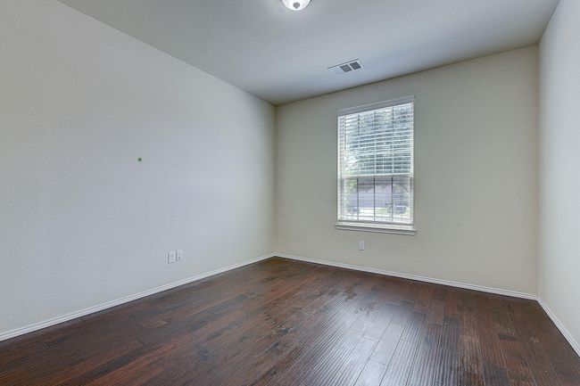 Spare room featuring dark wood-type flooring and baseboards | Image 9