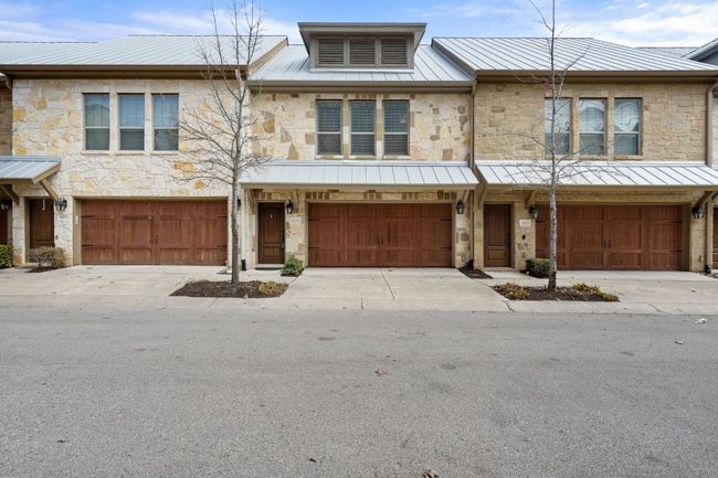 Townhome property with stone siding and metal roof | Image 37