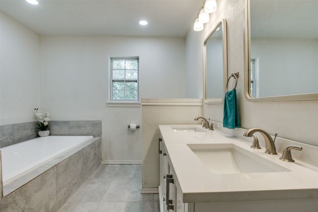 Full bath featuring a bath, double vanity, recessed lighting, and tile patterned floors | Image 20