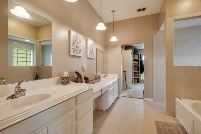 Full bath featuring a bath, visible vents, tile patterned flooring, and vanity | Image 12
