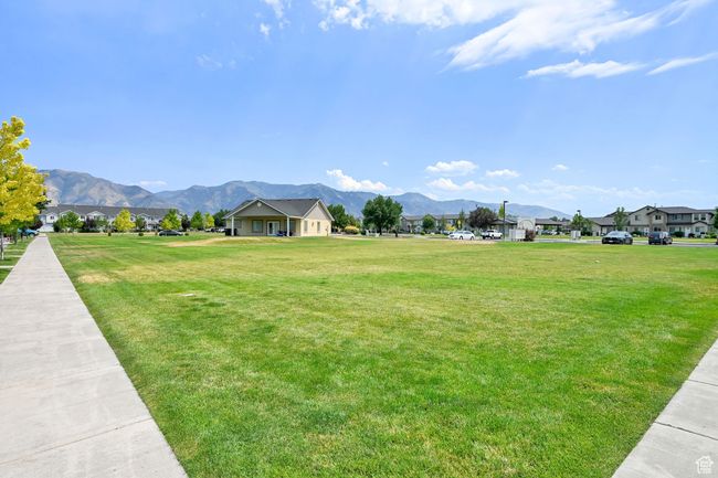 View of community featuring a mountain view, a residential view, and a yard | Image 35