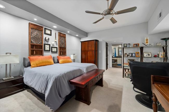 Primary bedroom with sitting area, walk-in closets with customized laundry bins, ensuite bath. | Image 26