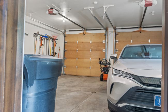 Spacious two car garage with flex room to the left, currently used as a workout room. | Image 58
