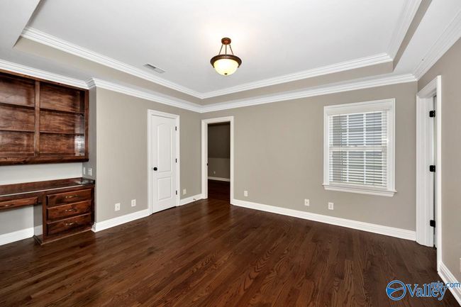 Wood flooring, crown molding, built-in desk and shelving | Image 31