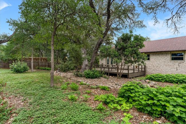 Backyard view of home and natural landscaping | Image 17