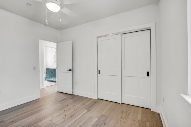 Unfurnished bedroom with light wood finished floors, baseboards, a closet, and a ceiling fan | Image 25
