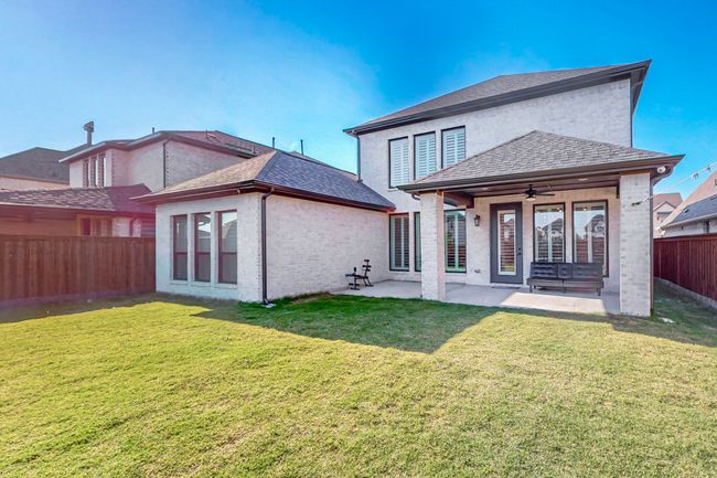 Back of property with a ceiling fan, a patio area, and brick siding | Image 37